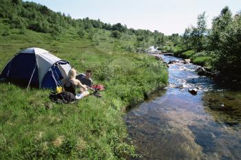 Royalty Free Photo of a Couple Camping By a Stream