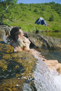 Royalty Free Photo of a Couple of Campers Relaxing in a Stream