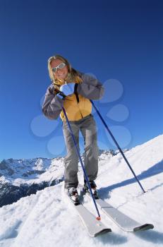 Royalty Free Photo of a Skier Standing Smiling on a Hill