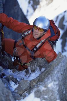 Royalty Free Photo of a Guy Climbing a Snowy Mountain