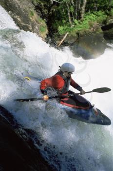 Royalty Free Photo of a Kayaker Going Over a Waterfall