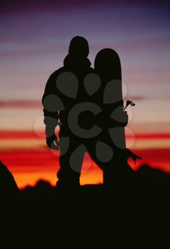 Royalty Free Photo of a Silhouetted Snowboarder at Dusk