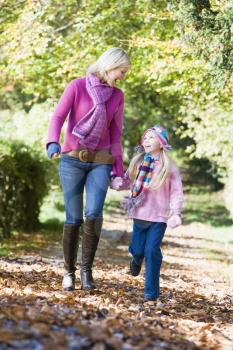 Royalty Free Photo of a Mother and Daughter Walking in a Park