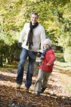 Royalty Free Photo of a Father and Son Walking in a Park