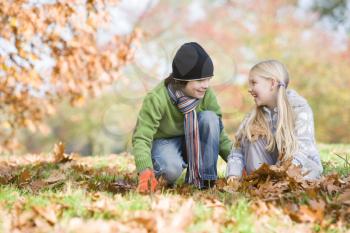 Royalty Free Photo of Children Playing in Leaves