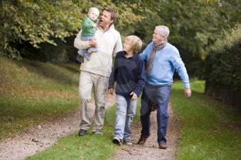 Royalty Free Photo of Three Generations of Men Walking on a Trail