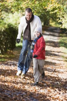 Royalty Free Photo of a Man and Boy Walking on a Path