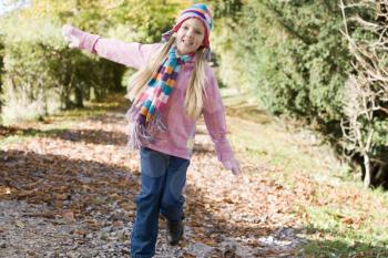 Royalty Free Photo of a Young Girl Running on a Path 