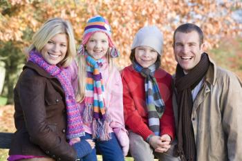 Royalty Free Photo of a Family on a Fence in the Fall