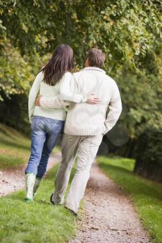 Royalty Free Photo of a Back View of a Couple Walking on a Trail
