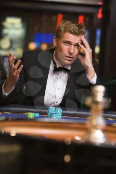 Royalty Free Photo of a Man Losing at a Roulette Table
