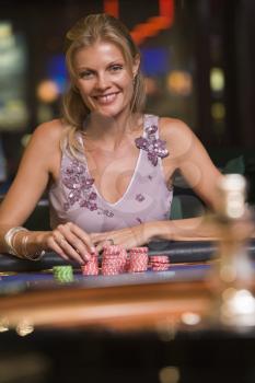 Royalty Free Photo of a Smiling Woman at a Roulette Table