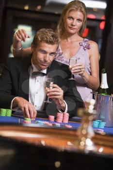 Royalty Free Photo of a Couple at a Roulette Table