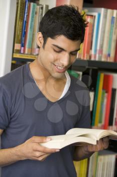 Royalty Free Photo of a Guy Reading a Library Book