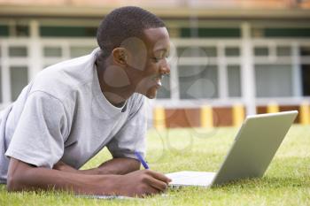 Royalty Free Photo of a Guy on the Lawn With a Laptop