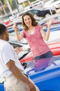 Royalty Free Photo of a Woman Getting the Keys for a New Car