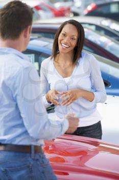 Royalty Free Photo of a Woman Shopping for a New Car