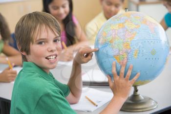 Royalty Free Photo of a Student Pointing to a Globe