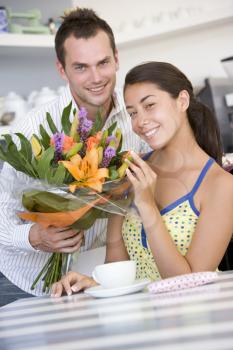 Royalty Free Photo of a Guy Giving a Girl Flowers