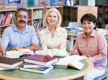 Royalty Free Photo of Three People at a Library Table