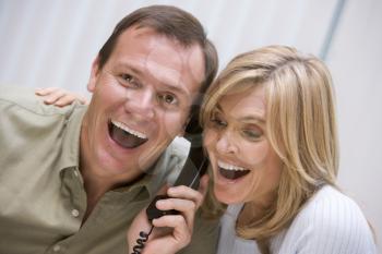 Royalty Free Photo of a Couple Hearing Good News