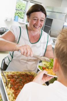 Royalty Free Photo of a Lunch Woman Serving Salad