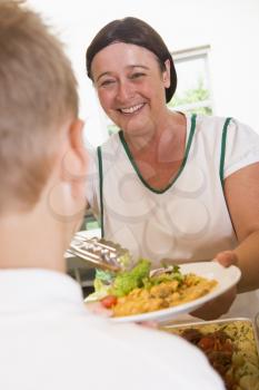 Royalty Free Photo of a Lunch Woman Serving a Student