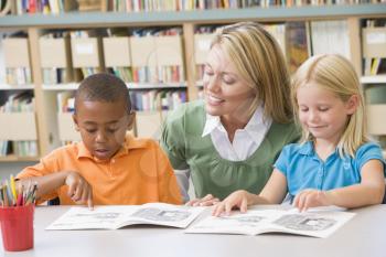 Royalty Free Photo of Students Reading With a Teacher