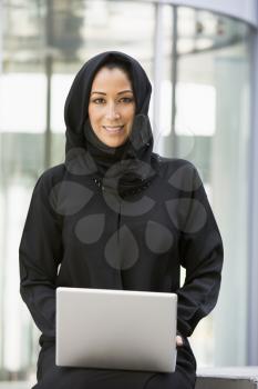 Royalty Free Clipart Image of an Eastern Woman With a Laptop