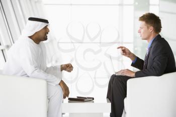 Royalty Free Photo of Two Men Talking in a Room
