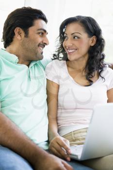 Royalty Free Photo of a Woman With a Laptop and a Man Beside Her
