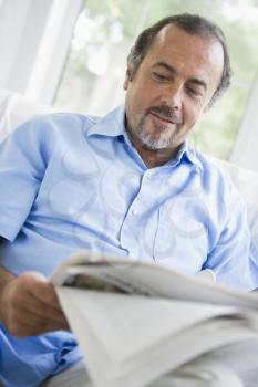 Royalty Free Photo of a Man Reading a Paper