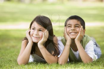 Royalty Free Photo of Two Children Lying on the Grass