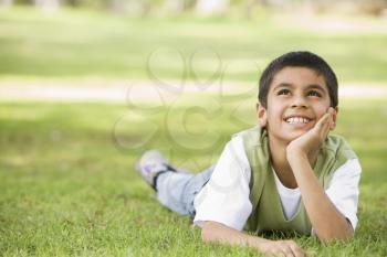 Royalty Free Photo of a Young Boy on the Lawn
