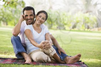 Royalty Free Photo of a Cople Outside on a Blanket
