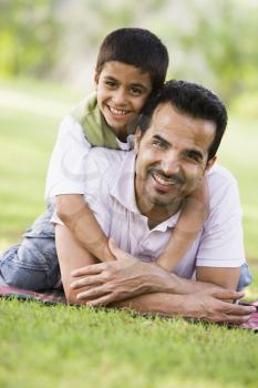 Royalty Free Photo of a Father and Son on the Lawn