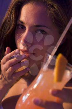 Royalty Free Photo of a Girl With a Drink and a Cigarette