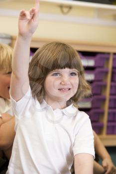 Royalty Free Photo of a Girl With Her Hand Raised