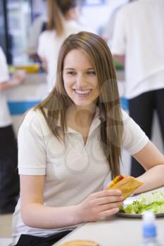 Royalty Free Photo of a Girl Having Lunch in a Cafeteria