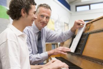 Royalty Free Photo of a Boy and Teacher at the Piano