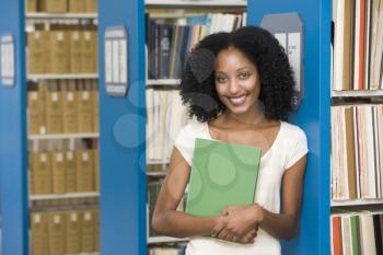 Royalty Free Photo of a Girl in the Library With a Book