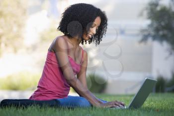 Royalty Free Photo of a Girl Outside With a Laptop