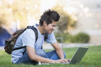 Royalty Free Photo of a Guy Outside With a Laptop