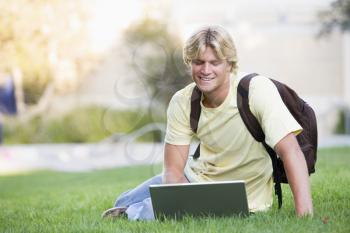 Royalty Free Photo of a Guy on the Lawn With a Laptop