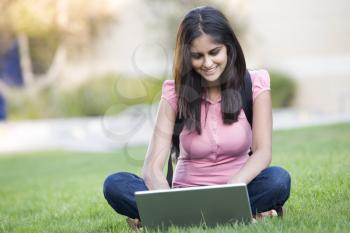 Royalty Free Photo of a Girl Outside With a Laptop