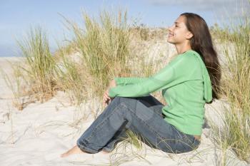 Royalty Free Photo of a Young Woman Sitting on Sand