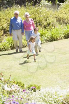Royalty Free Photo of Grandparents in the Garden With Their Grandchildren