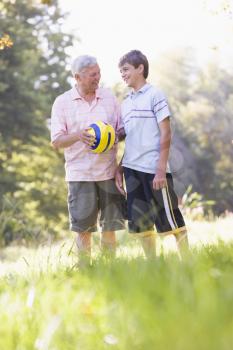 Royalty Free Photo of a Grandfather and Grandson With a Ball