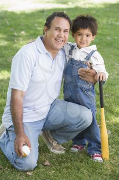 Royalty Free Photo of a Man and Grandson With a Bat and Ball