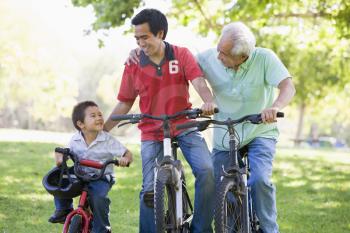Royalty Free Photo of Three Generations of Males on Bikes